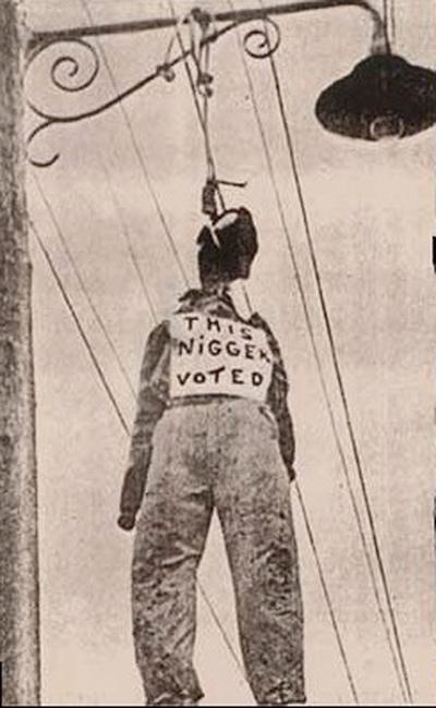 A 1940 photograph of a life-size effigy suspended above a Miami street to intimidate Black voters